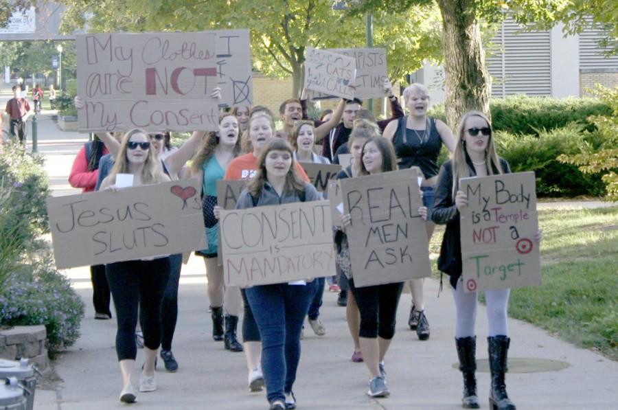 Students chanted and raised hand-written signs during the SLUT Walk on Tuesday while marching past the Biological Sciences building.