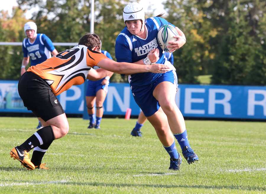 Madison Overbey, a freshman lock on the Eastern rugby team, powers the ball past a University of Tennessee player on Saturday at Lakeside Field.