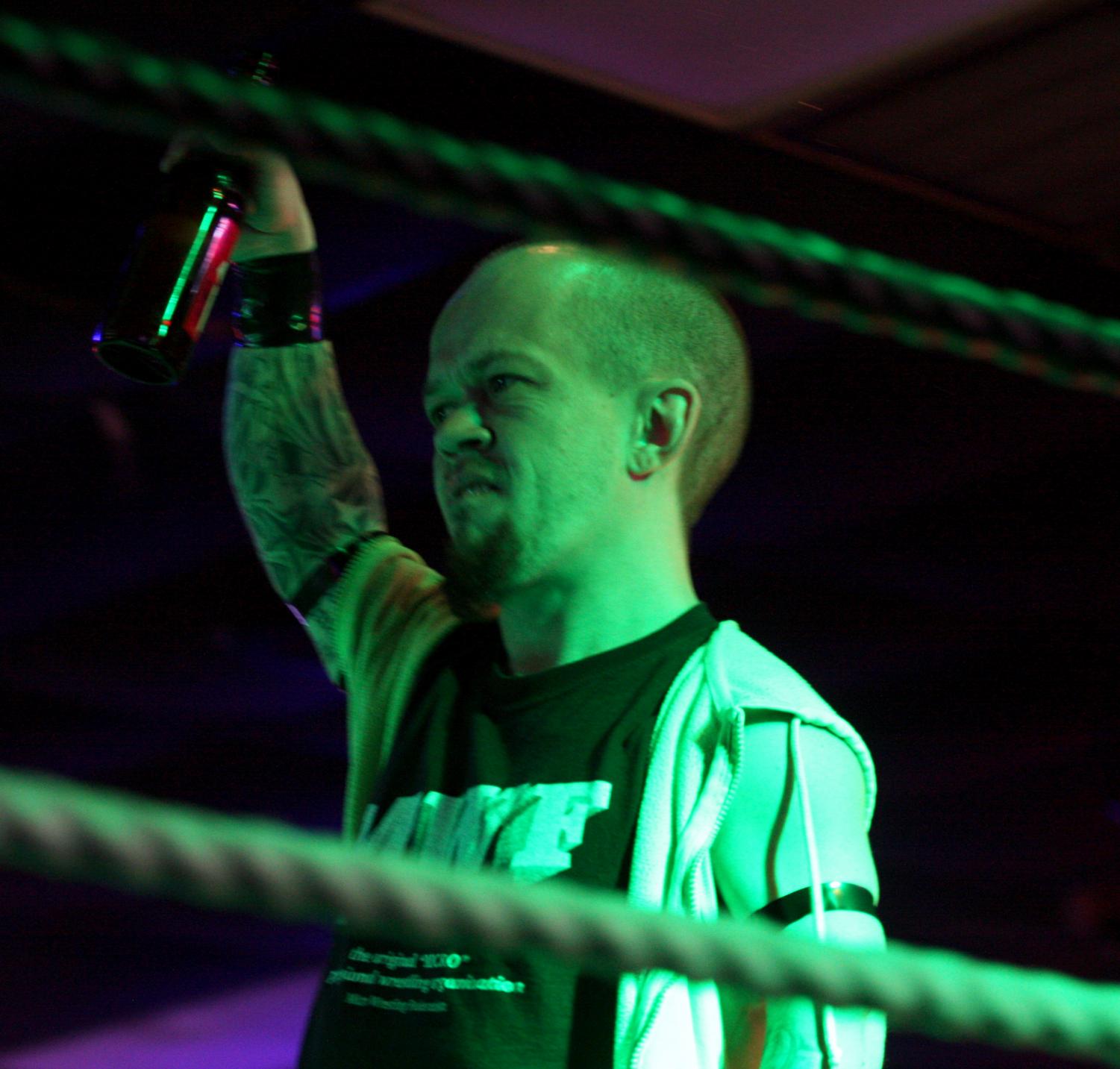 JJ Bullock | The Daily Eastern “The Enigma” of the Micro Wrestling Federation holds a beer up for the crowd at the Panther Paw. 