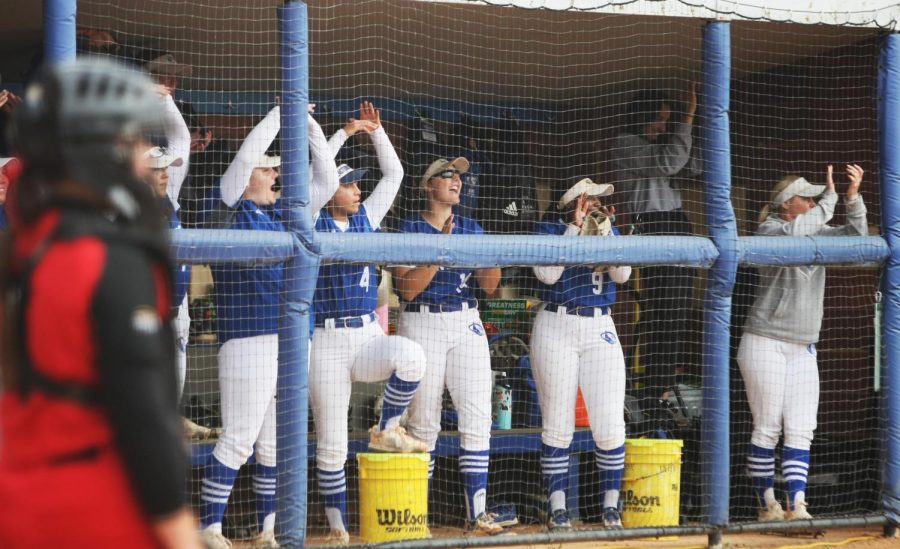 The softball team cheers after a player gets a double at Williams Field Tuesday afternoon.