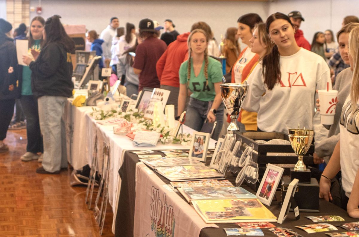 Students stand behind their booths to promote their oranizations at Pantherpalooza in the Martin Luther King Jr., University Union Grand Ballroom on Eastern Illinois University's campus on Tuesday, Jan. 16, 2024. 
©CAM'RON HARDY | THE DAILY EASTERN NEWS