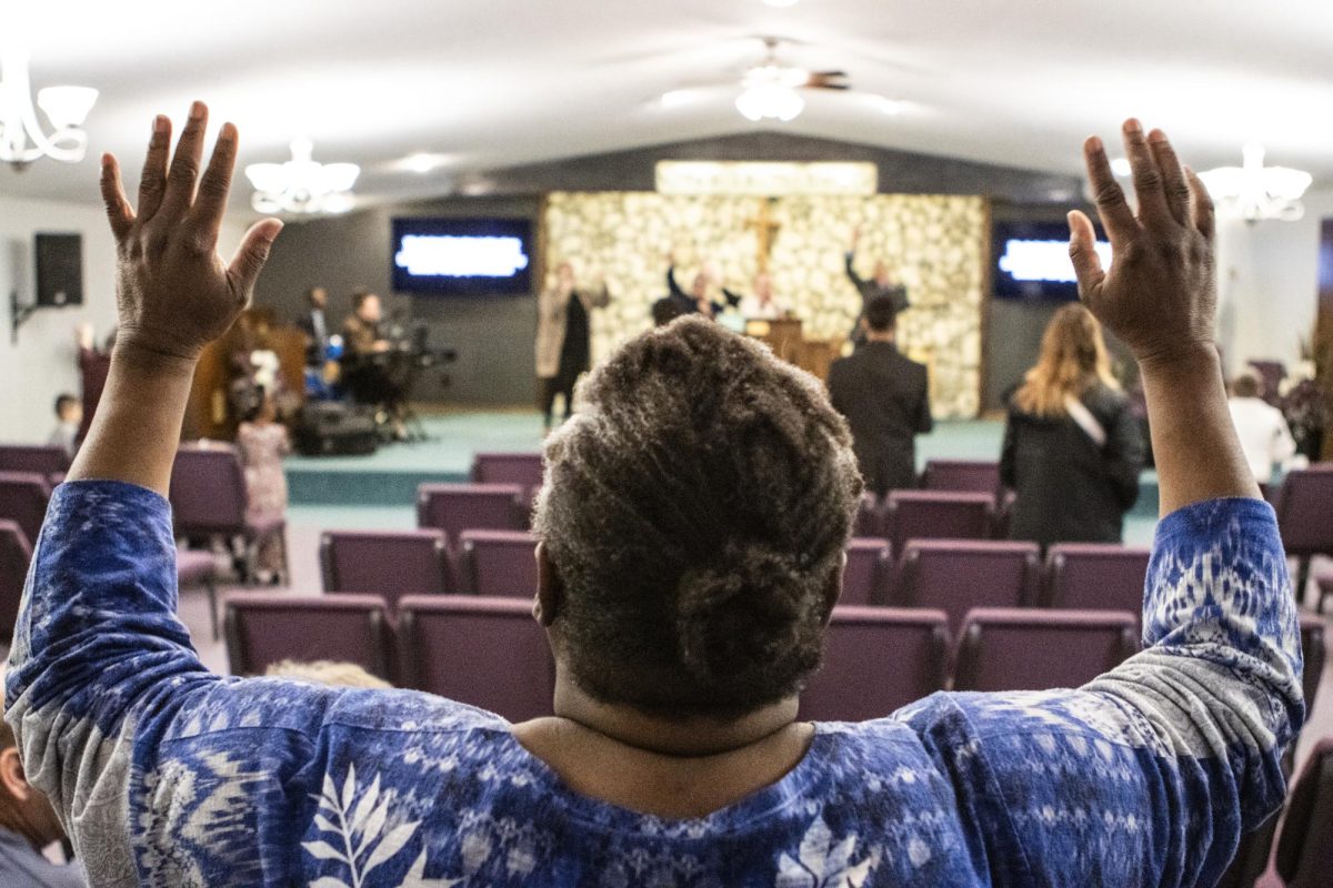 Marschelle McCoy raises her arms in praise during Wisdom Wednesday service at United Pentecostal Tabernacle Feb. 28.
