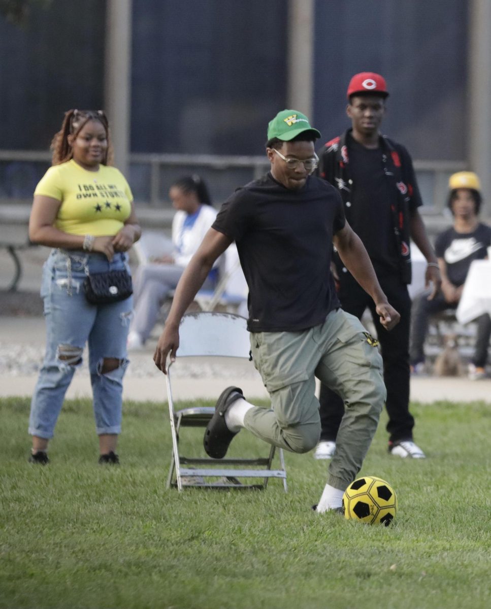 Junior computer science major Cov Dennis goes to kicks the ball during the kickball game hosted by the Black Student Union during their Find Your Friend Color Picnic Thursday, Aug. 22, 2024 in the Library Quad of Eastern Illinois University’s campus.