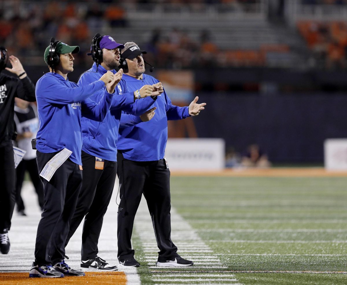 Eastern's coaching staff directs players in between plays during the team's home opener against University of Illinois Urbana-Champaign at Memorial Stadium in Champaign Thursday night. The Panthers were shut out 45-0 against the Fighting Illini.