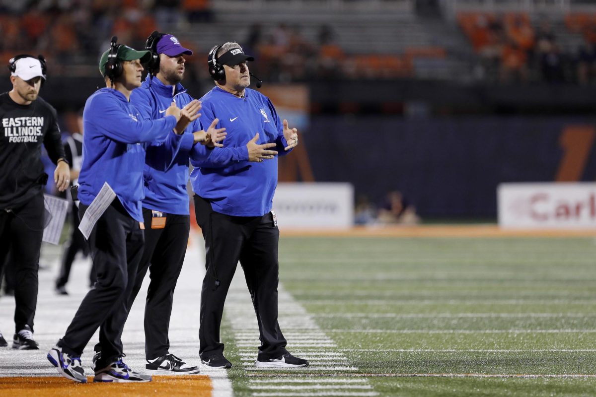 Eastern's coaching staff directs players in between plays during the team's home opener against University of Illinois Urbana-Champaign at Memorial Stadium in Champaign Thursday night. The Panthers were shut out 45-0 against the Fighting Illini.