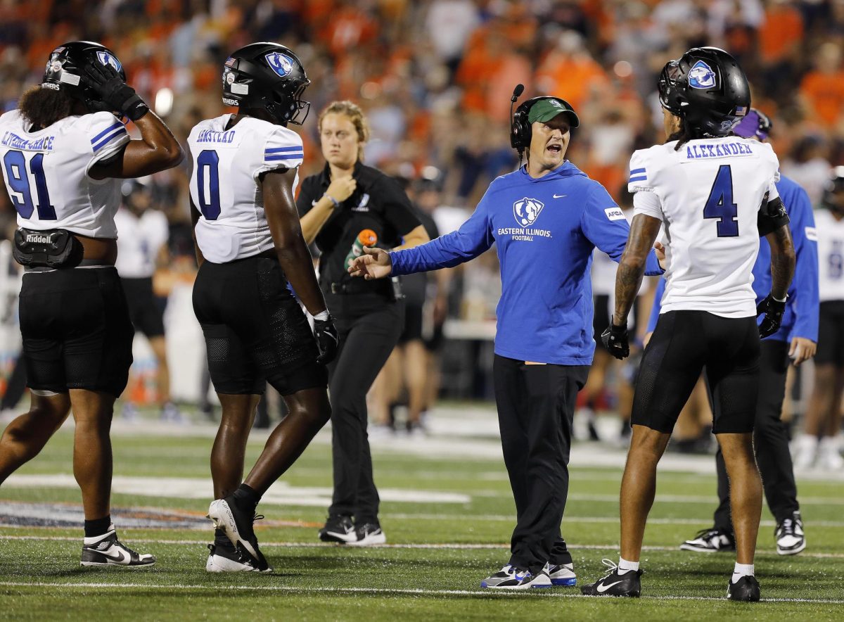 EIU assistant coach Andrew Strobel directs players after the the University of Illinois at Urbana-Champaign score a touchdown during the team's season opener at Memorial Stadium Thursday night. The Panthers were shut out 45-0 against the Fighting Illini.