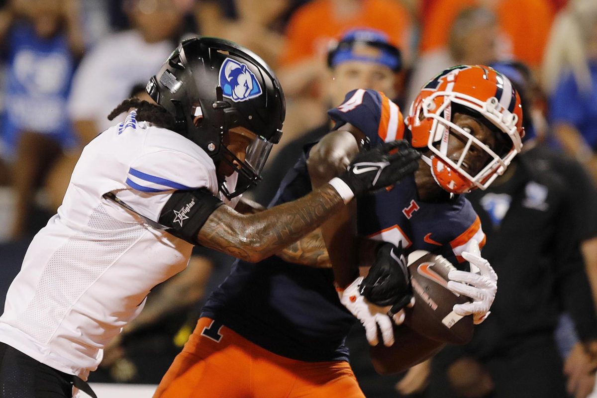 Illinois wide receiver Zakhari Franklin catches the ball in the end zone as EIU redshirt defensive back junior Moses Alexander attempts to intercept during the team's season opener against the Fighting Illini at Memorial Stadium Thursday night.