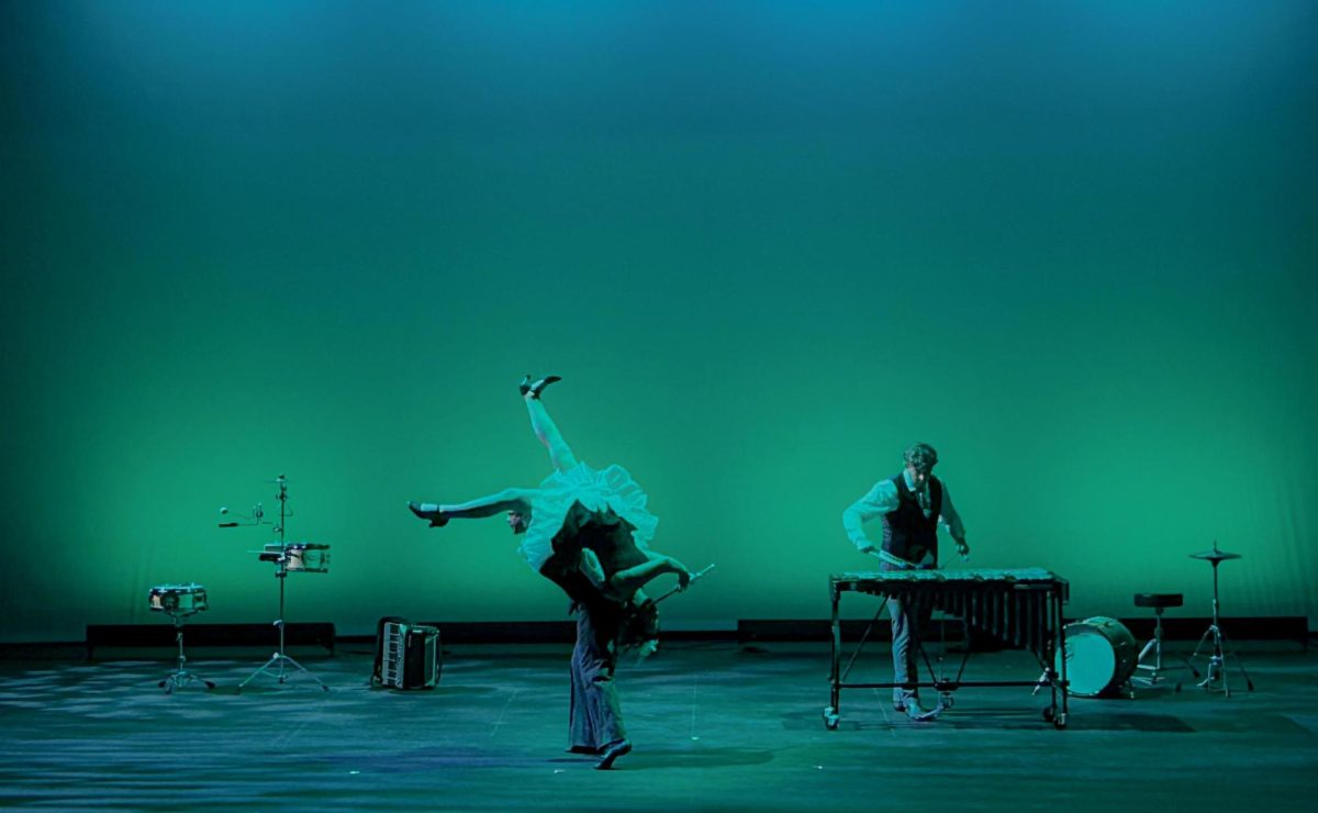 The Fourth Wall’s Hilary Abigana playing the flute upside down for “Fruit Flies Like a Banana” in The Theatre at Doudna Performing Arts Center