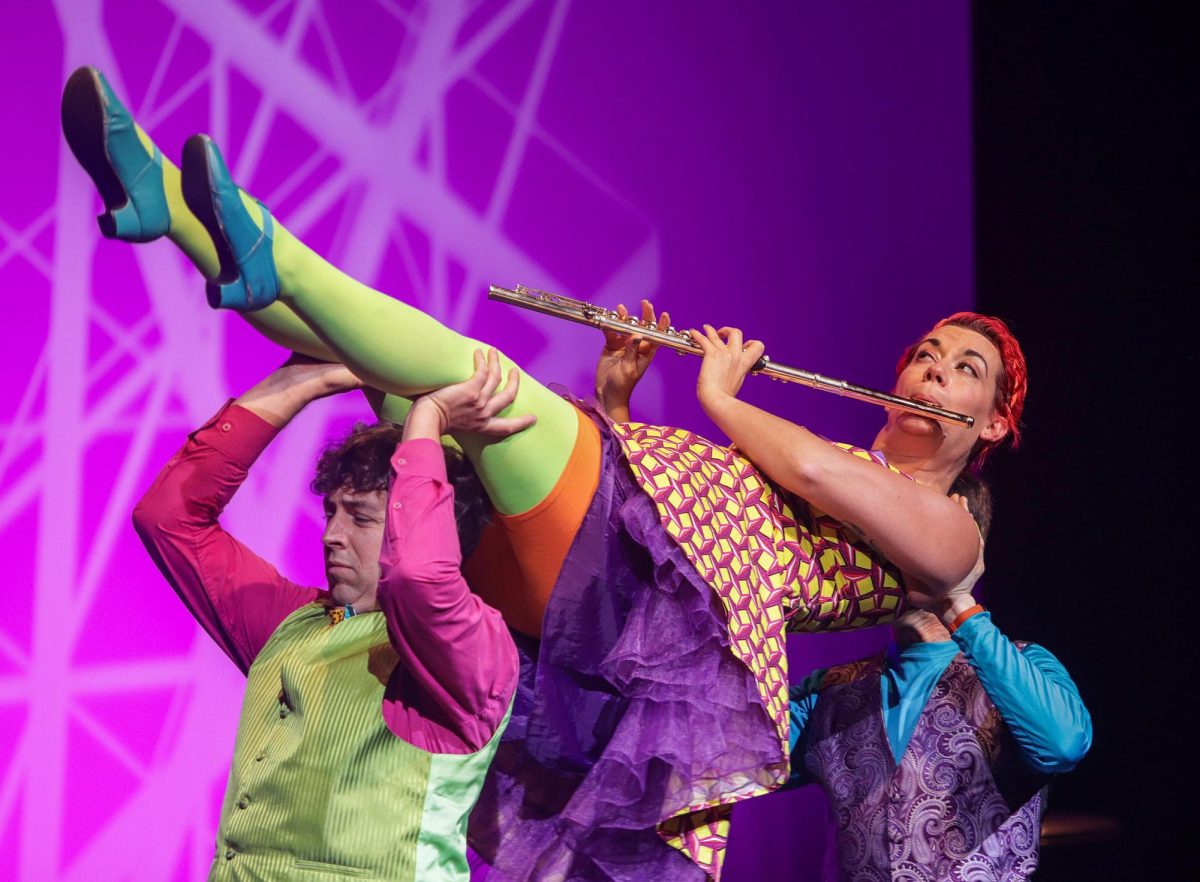 SUBMITTED PHOTO | THE DOUDNA FINE ARTS CENTER
Hilary Abigana is hoisted up while playing the flute during  the final song of the night labeled as "Straw Yellow" ("La Escoba" traditional by arr. Terry L. Baldrige) "Fruit Flies Like a Banana" at The Theatre in Doudna Fine Arts Center Saturday. During the show, the group integrates acrobatics and dances, while having ample audience engagement.