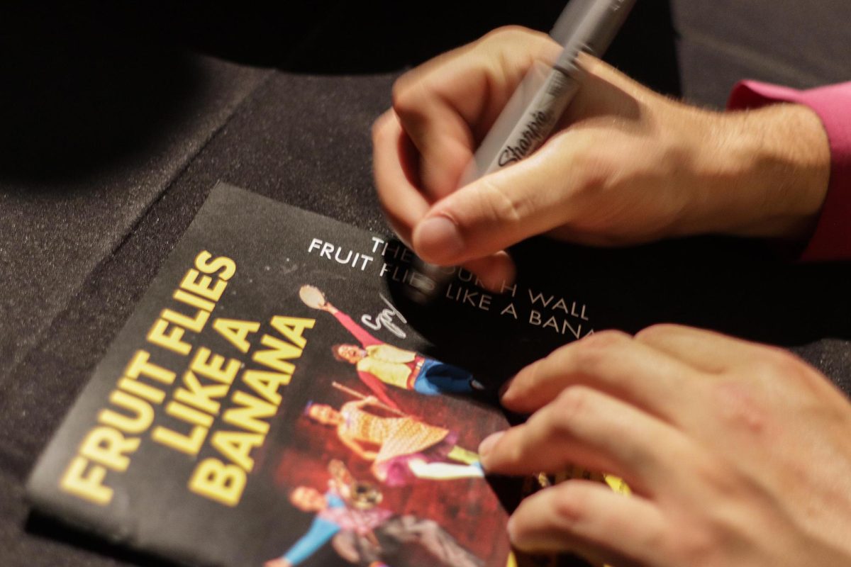 SUBMITTED PHOTO | THE DOUDNA FINE ARTS CENTER
Greg Jukes autographs a playbill for a student after "Fruit Flies Like a Banana" at The Theatre in the Doudna Fine Arts Center Saturday.