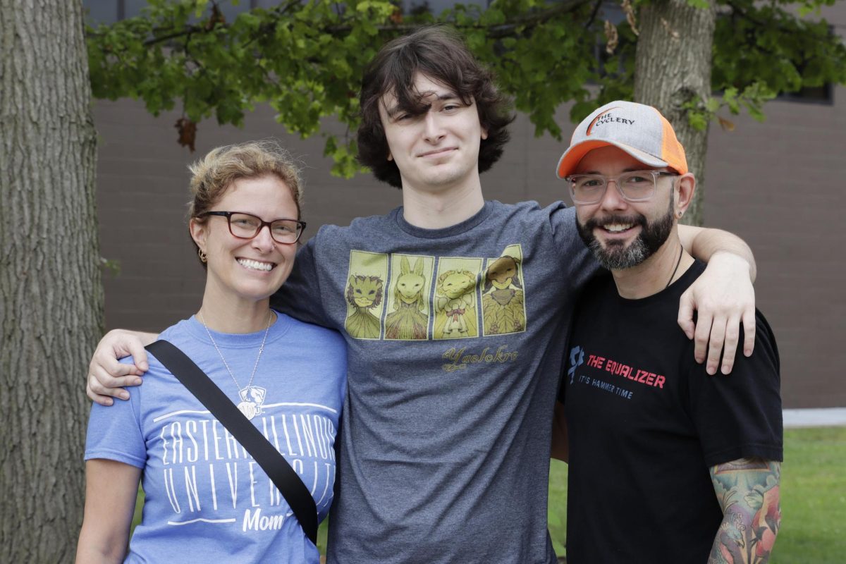 Parents Erica White (left) and Justin White (right) hug their son Gabe White (middle), a freshman accounting major, on Thursday outside the Doudna Fine Arts Center on Move In Day. The parents said it was bittersweet to see their son leave but are excited for him to start college. 