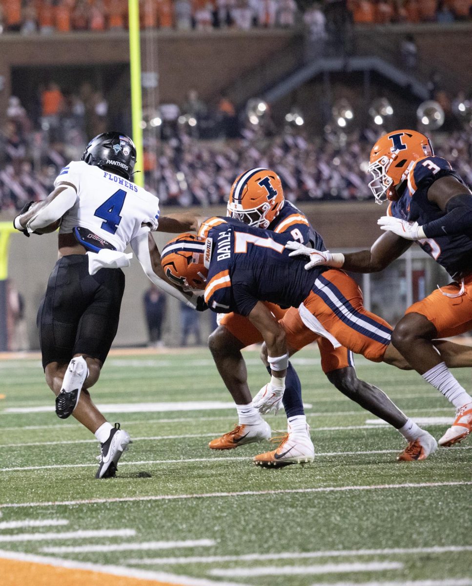 Redshirt sophomore running back MJ Flowers about to get tackled during the season opener game at the Memorial Stadium in Champaign Ill, Thursday, August 30, 2024.