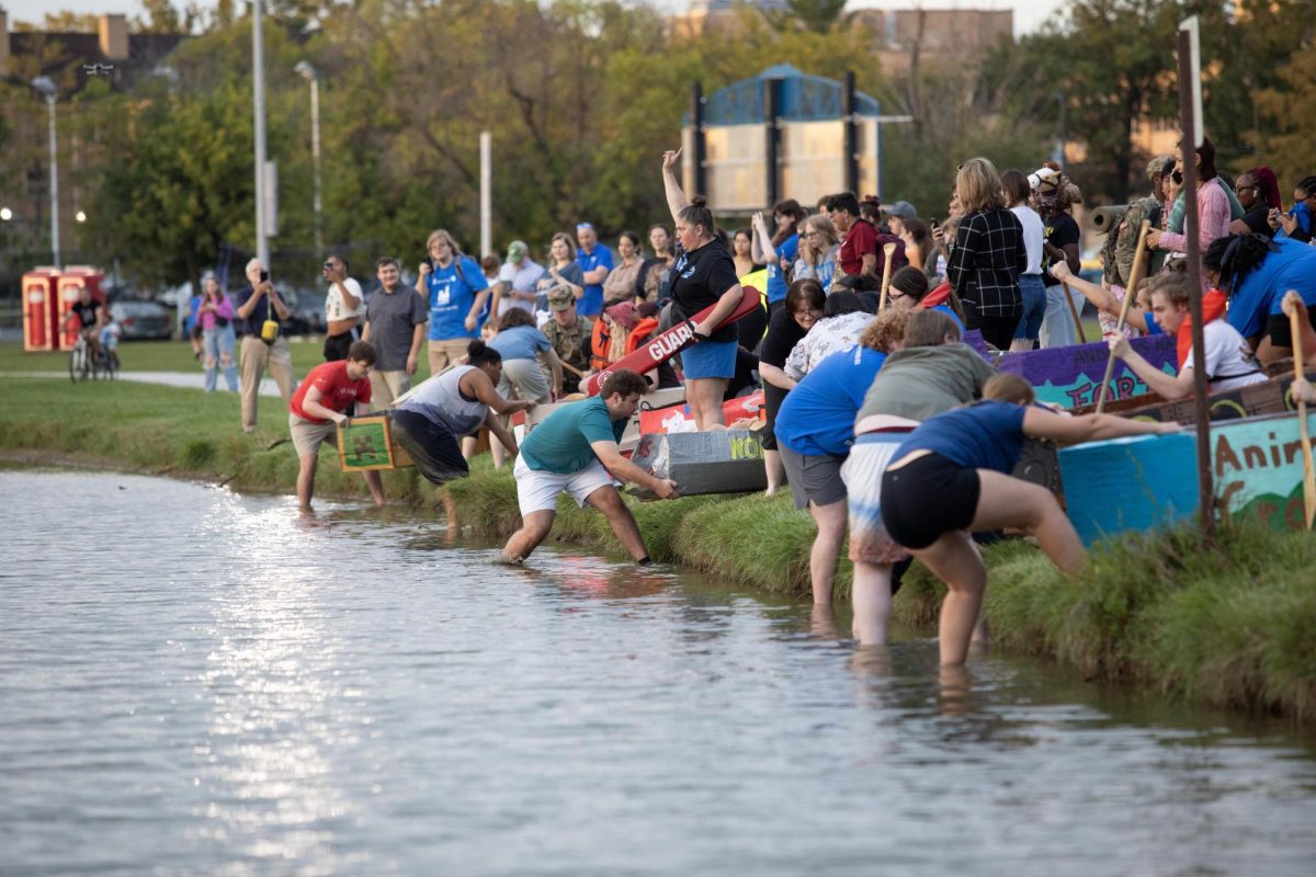 The resident hall association starts the cardboard boat race with all the halls of campus during Neighborhood Week at the Campus Pond.