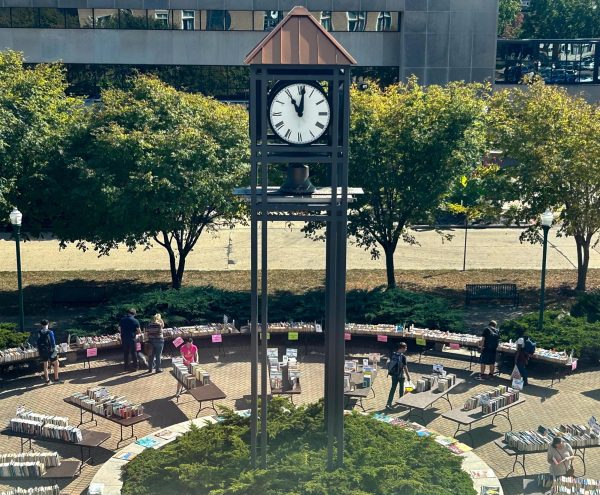 Eastern Illinois University students browse the Fall Book Sale around the Alumni Clocktower in front of Booth Library Wednesday.