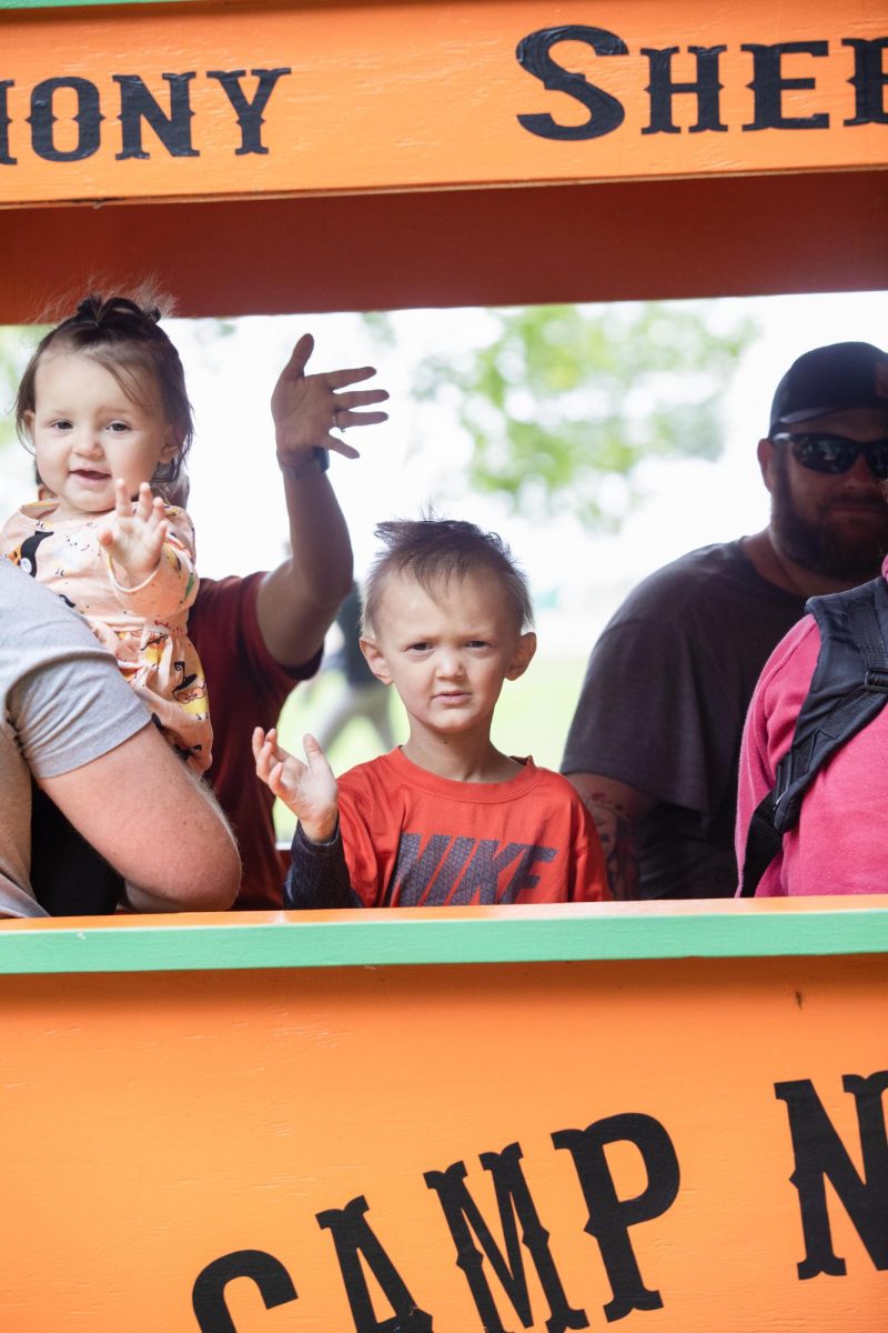 Four-year-old Jackson waves as the Camp Hope train passes by with his sister 6-year-old Charolette during the Camp New Hope 50th Anniversary Celebration at Camp New Hope.