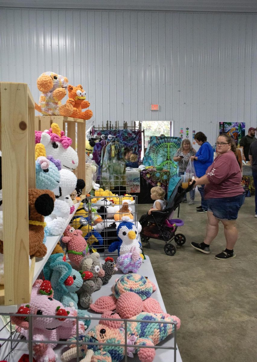 Vendors sell colorful crochet animals at the Camp New Hope 50th anniversary celebration. 