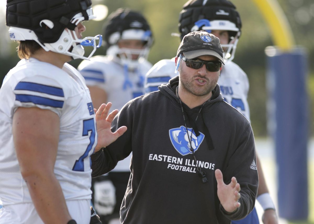 Offensive line coach John Cannova instructs players on proper form during football practice at O'Brien Field Wednesday afternoon.