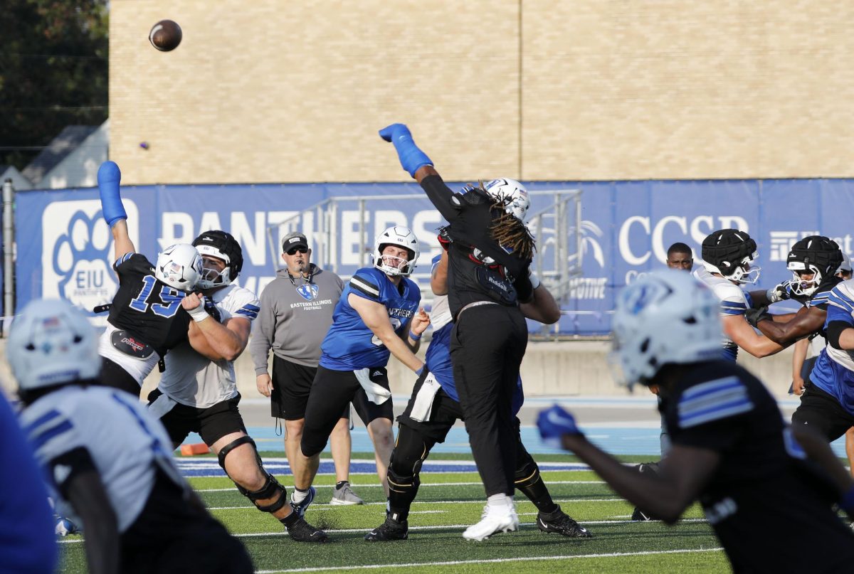 Graduate quarterback Pierce Holley throws the ball forward during football practice at O'Brien Field Wednesday afternoon.