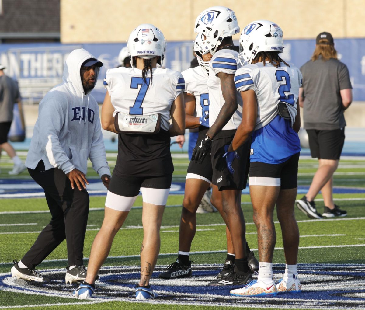 Wide receivers coach Tino Smith instructs players after a play during football practice at O'Brien Field Wednesday afternoon. 