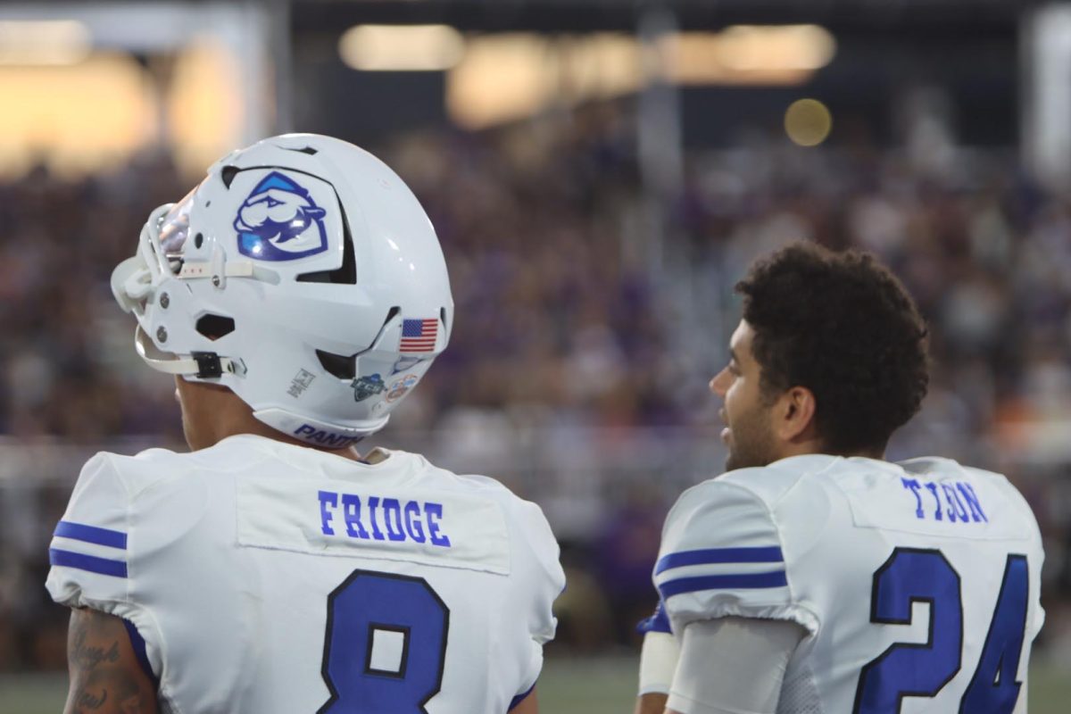 Senior safety Tienne Fridge (left) and redshirt junior safety Collin Tyson (right) look on out to the Northwestern Medicine Field at Martin Stadium from the sideline. Eastern lost to Northwestern Saturday evening in Evanston with a final score of 31-7.