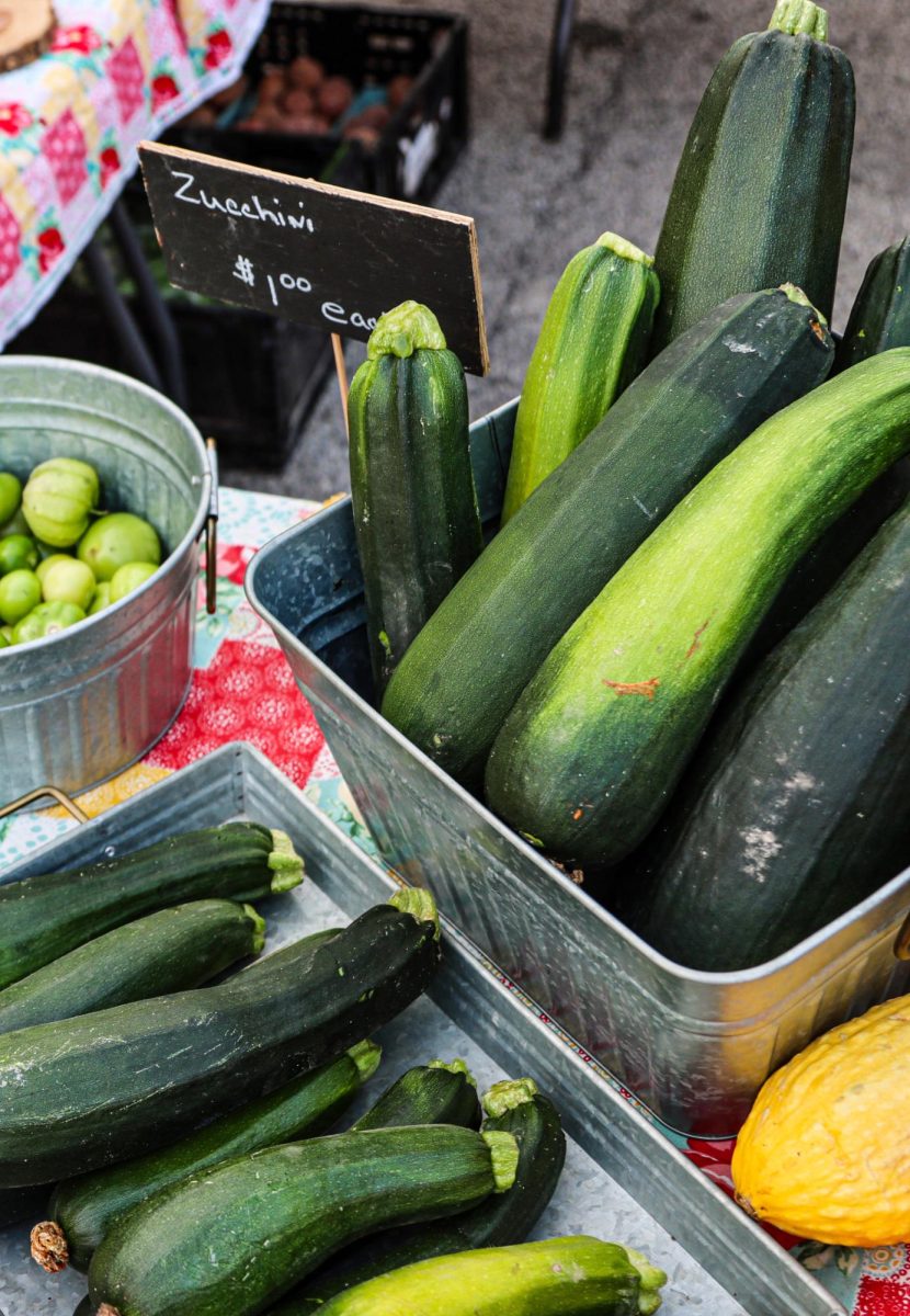 Zucchinis for only a dollar each sit on a table at the Charleston farmer's market.