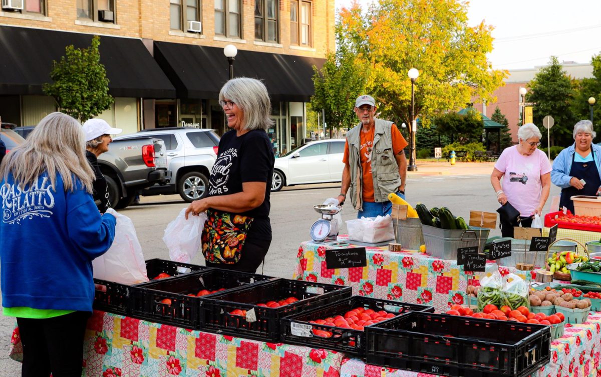 The Charleston community comes to buy and support small, locally grown vegetable stands in front of the Coles County Courthouse Wednesday morning.