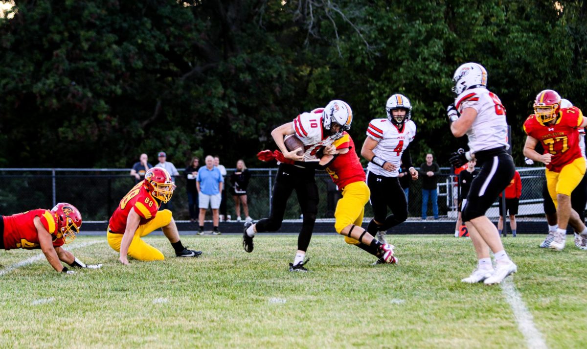 Paris high quarterback drew rogers gets sacked in the backfield after trying to scramble away from the Charleston defender at Trojan Hill Charleston