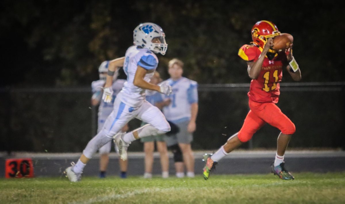 Charleston sophomore running back Treylin Couch bobble the ball before securing it and running for his fourth touchdown during the third quarter of Charleston’s 45-34 win against Jersey on Sept 13, 2024, in Charleston Illinois. 