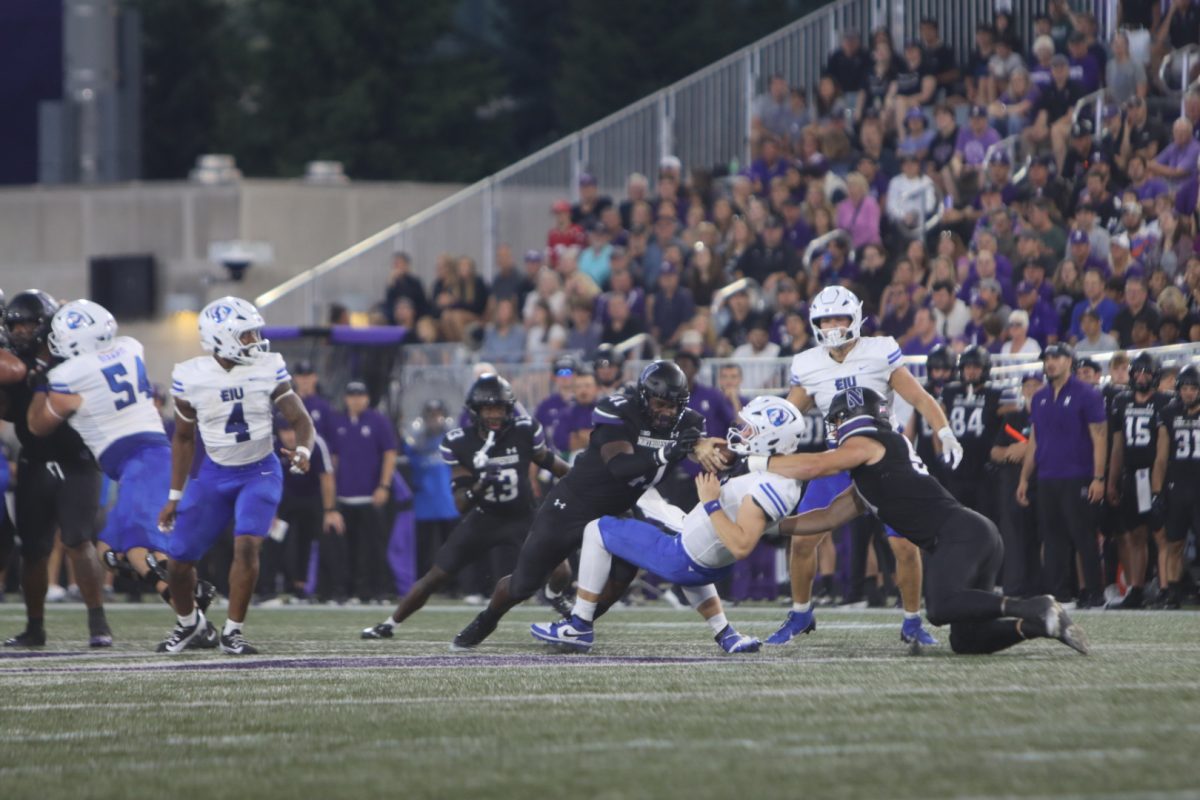 Graduate quarterback Pierce Holley gets tackled by two Northwestern defenders. The Panthers lost to the Wildcats 31-7 Saturday evening at the Northwestern Medicine Field at Martin Stadium in Evanston, Illinois.