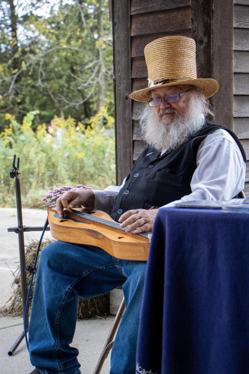 Mike Anderson plays a mountain dulcimer at the at Harvest Frolic at the Lincoln Log Cabin State Historic Site, Charleston Ill. Saturday afternoon. Sept. 28, 2024. Anderson has been playing for over 40 years.