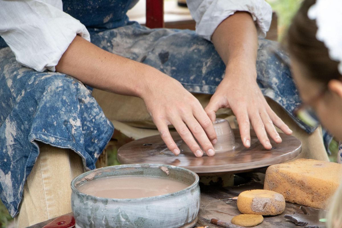 Sophomore at Cumberland High School Isaac Venatta makes a pot at his shared artisan stand at the Lincoln Log Cabin State Historic Site.