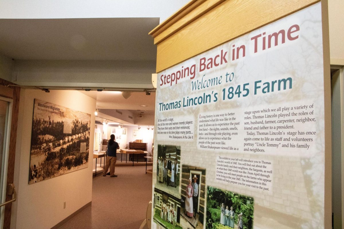 A sign reading “Stepping back in time” introduces the historical exhibition of Sarah Bush and Thomas Lincoln’s farm at the Lincoln Log Cabin State Historic Site.