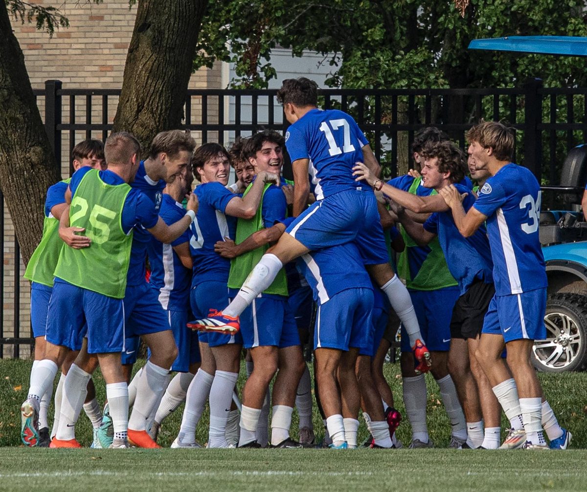 Freshman, Defender Sebastian Piatkiewicz, Jumps on the team after getting their first goal of the game against University of Chicago 