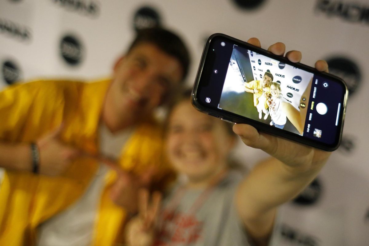 Gabe Schonman poses with a fan after the Radius show at the Doudna Fine Arts Center Saturday evening.