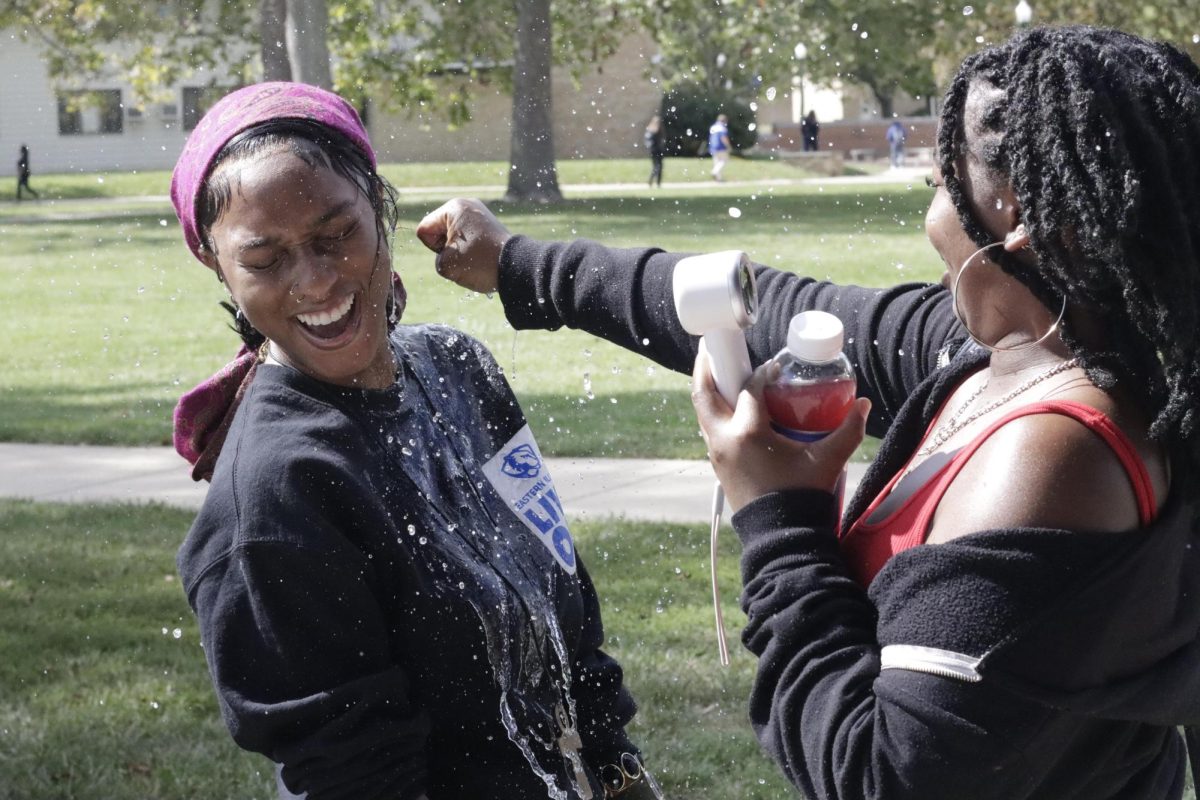 Kajah Williams, a senior 2d studio art major, gets splashed by a water balloon by Jamaya Fuller, a junior digital media major, at the Splash-A-Kat event fundraiser