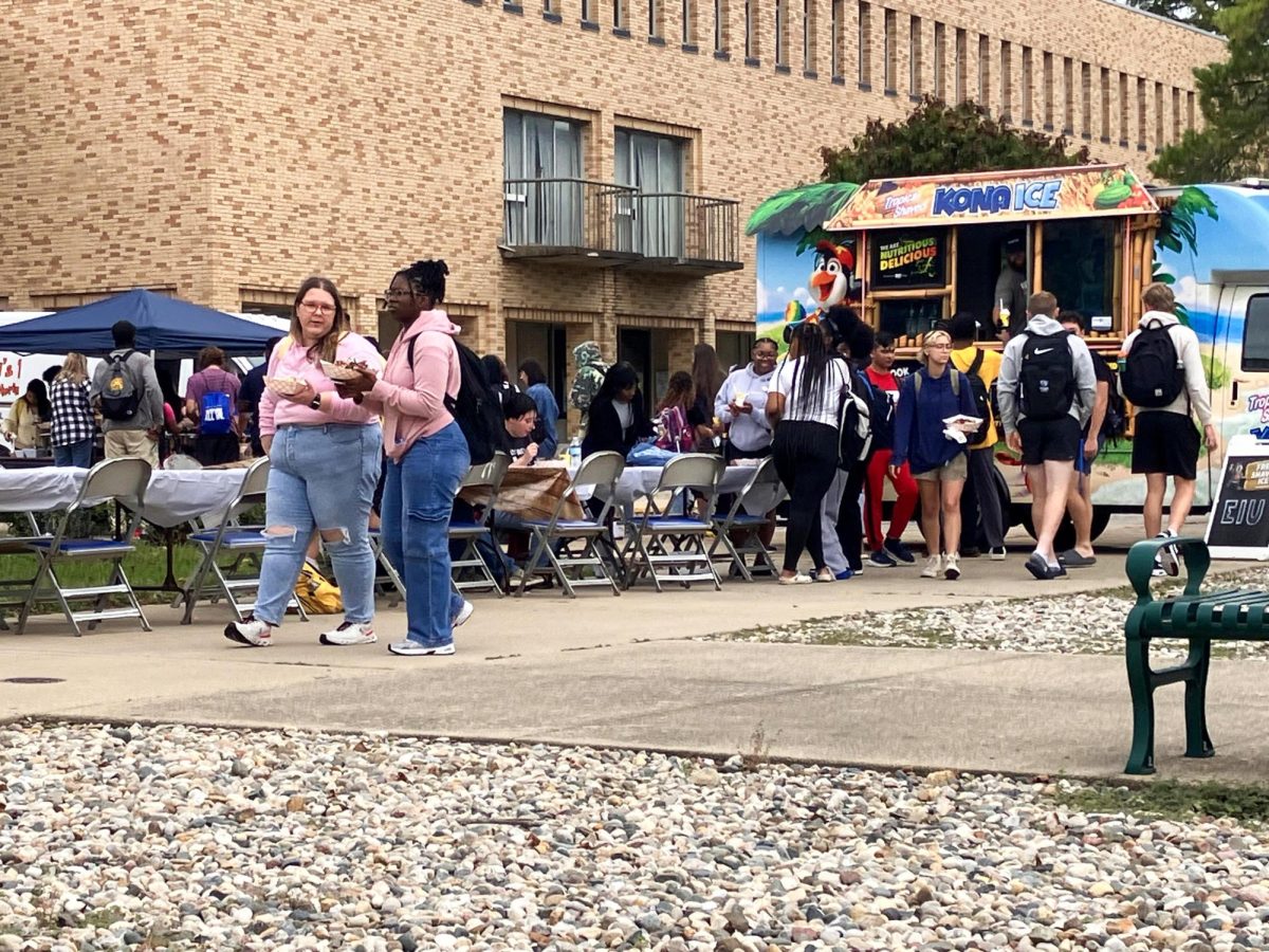 Students stop by for free shaved ice and nachos for Boots and BBQ in the Library Quad Monday.