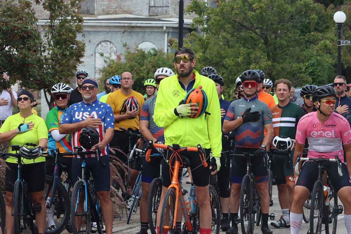 Bikers stand for the national anthem before the 25-mile race of the Tour De Charleston on Saturday morning in the Charleston Square. 