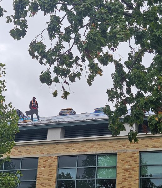 Construction workers replace the roof on Buzzard Hall at Eastern Illinois University in Charleston, Ill. 
