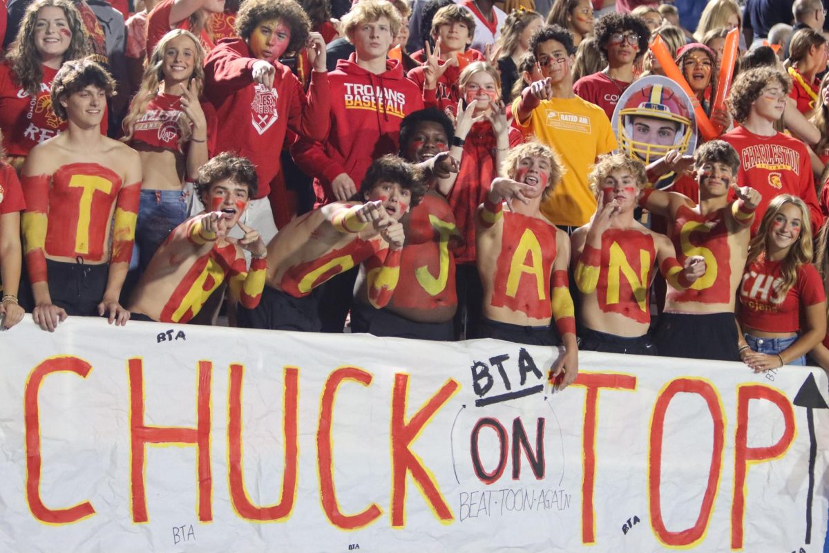 Charleston High Trojan fans getting ready with body paint and posters for the Coles County Clash against Mattoon at O’Brien Field on October 4. Charleston lost 20-10.