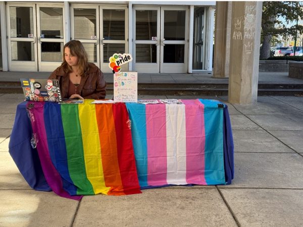 Katie Gillespie, a junior English education major and the president of EIU Pride on Saturday, Oct., 19, 2024,  selling pre-sale tickets for the EIU Drag Show at the overhang of Coleman Hall on Thursday, Oct. 17, 2024 in Charleston, Ill., at Eastern Illinois University. 