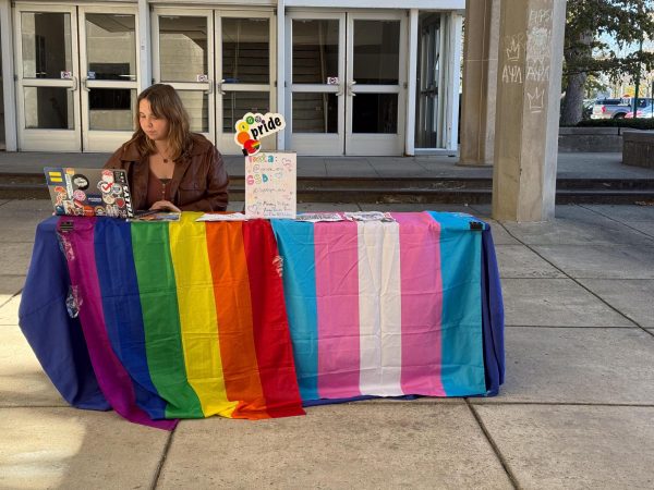 Katie Gillespie, a junior English education major and the president of EIU Pride on Saturday, Oct., 19, 2024,  selling pre-sale tickets for the EIU Drag Show at the overhang of Coleman Hall on Thursday, Oct. 17, 2024 in Charleston, Ill., at Eastern Illinois University. 