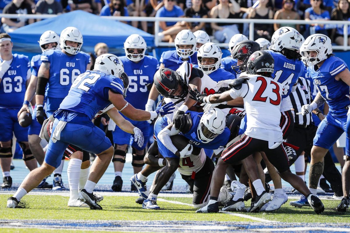 Sophomore running back MJ Flowers, is tackled by Southeast Missouri State University's defensive line after securing a first down for the EIU Panthers during Eastern's homecoming at O'Brien Field against Southeast Missouri State University Saturday afternoon. The Panthers lost 34-27 against the Redhawks.