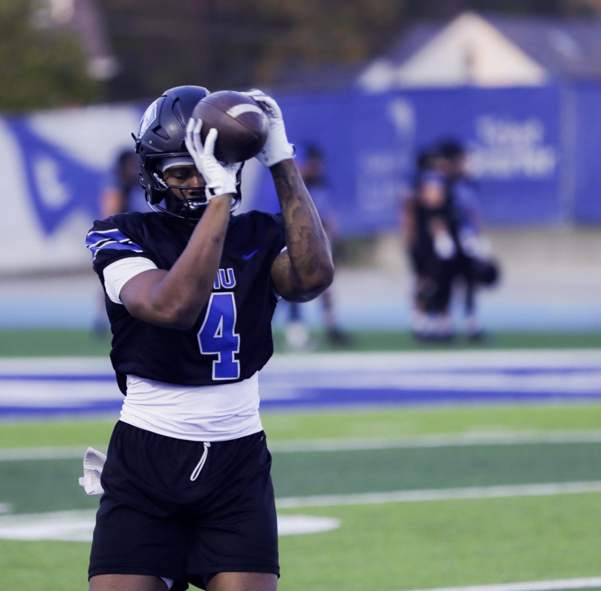 Running back Redshirt Sophomore MJ Flowers, Gets the ball during practices and holds is form before throwing it back.  on O'Brien Field