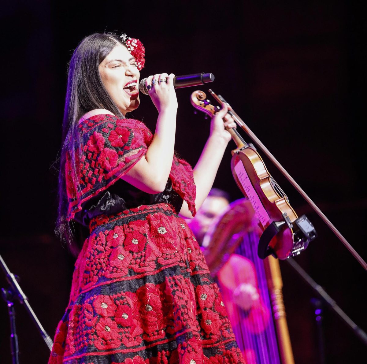 Violinist and vocalist Maria Reyes sings a solo during Grupo Bella's performance in the Dvorak Concert Hall in the Doudna Fine Arts Center Saturday evening. 