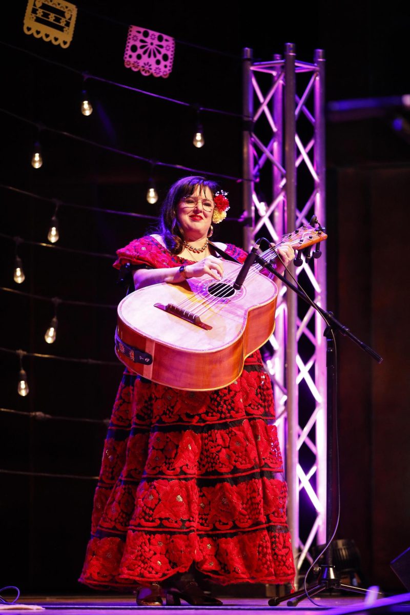 Guitarron player Diana McConell plucks strings during Grupo Bella's performance Saturday evening in the Dvorak Concert Hall in the Doudna Fine Arts Center. 