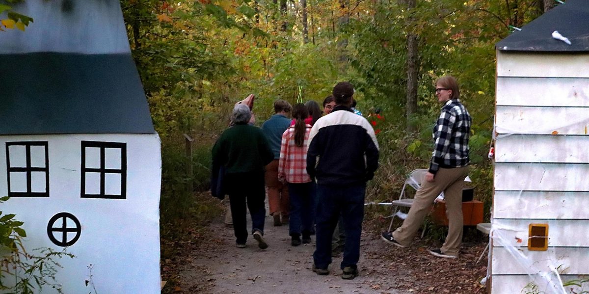 A group of participants at the Haunted Hike go through the first station of Douglas Hart Nature Center's "Beetlejuice" themed 14th annual Halloween event. 
