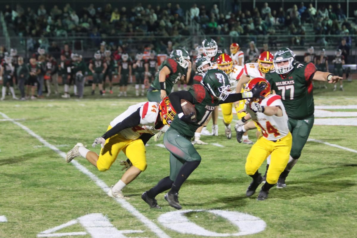 Salem sophomore running back Marquis Ettress stiff arms senior linebacker Ben Coffey and runs past senior defensive end Marcellx Boling during the first quarter of Charleston’s 35-10 loss to Salem on October 25 in Salem.