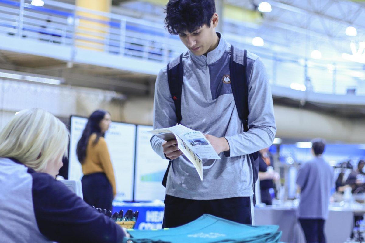 Wesley Koeppl a freshman in physical education checking out the Dail-A-Ride stand at the health and Wellness fair in the Eastern Illinois University rec center, 