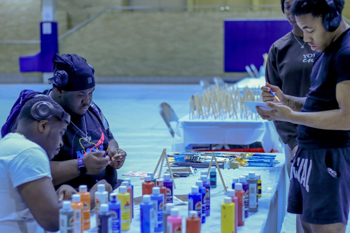 Don Pryor, Mari King, and Tjay Cooper all freshmen all enjoy a bit of painting at the paint table at the health and Wellness fair