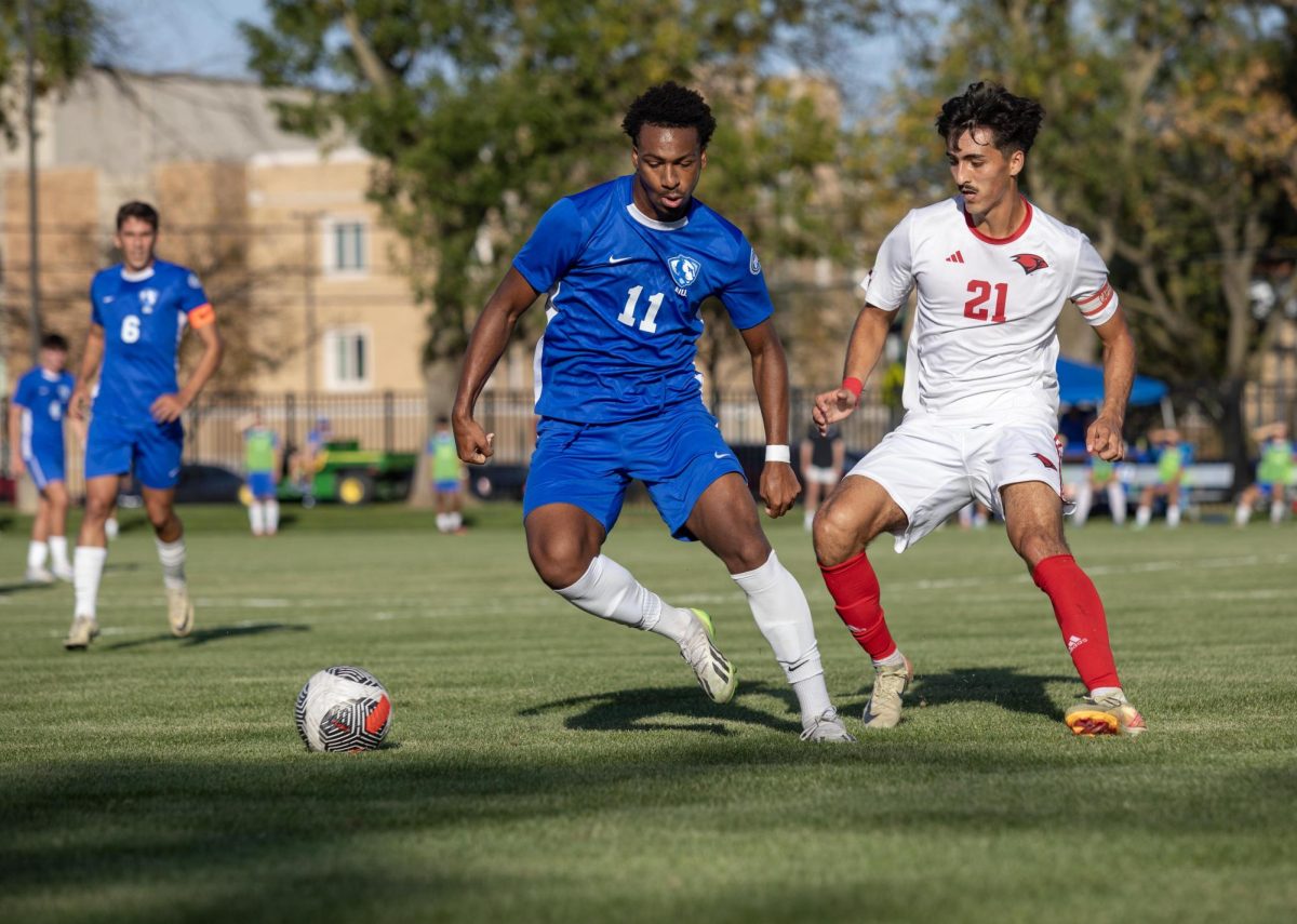 Number 11 Adam Boykin a forward freshman for Eastern Illinois University keeps the ball away from Middle field 21 Timothy Ospina player for University of Incarnate word, at the Lakeside Field on the Eastern Illinois University campus, 